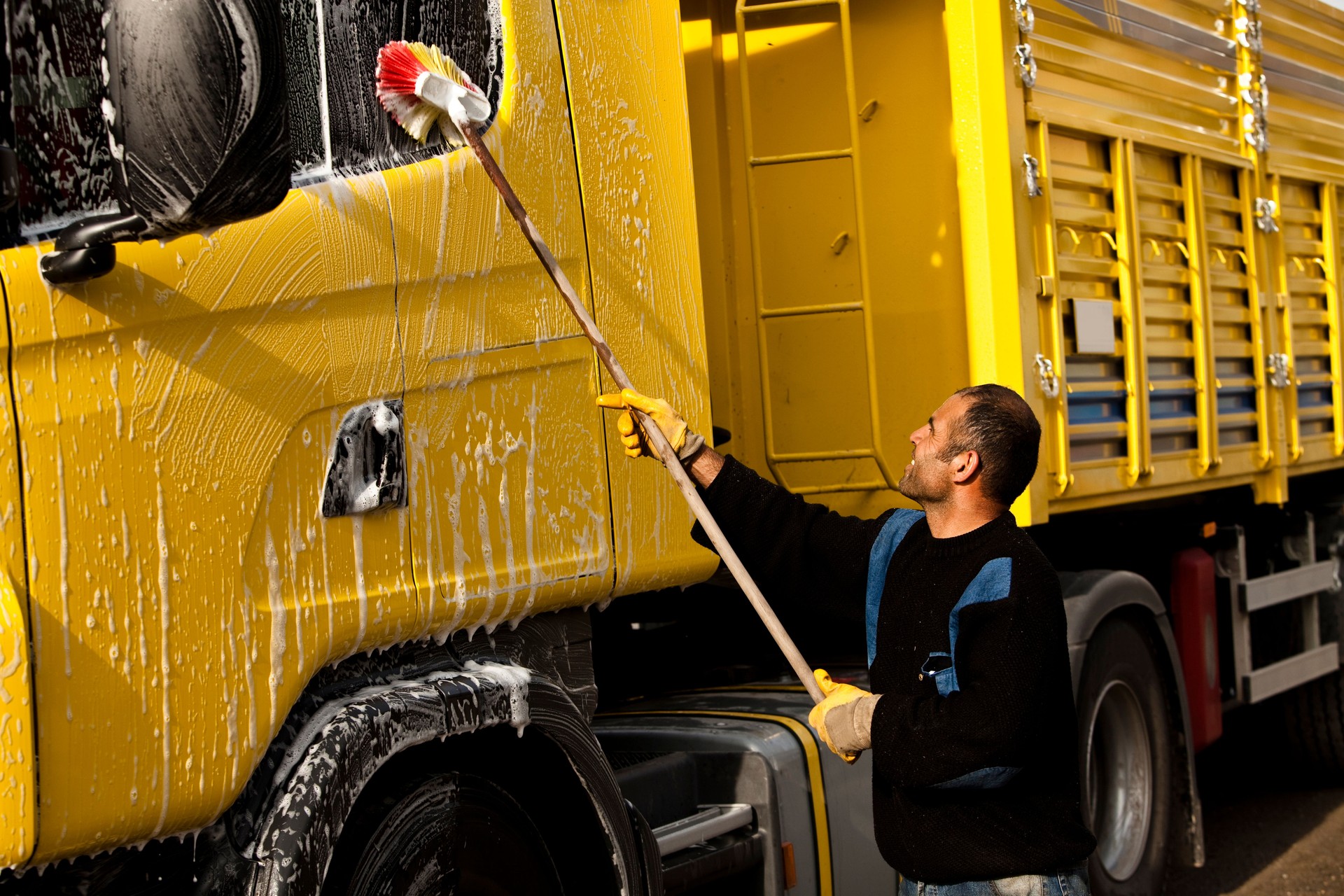 Mature man washing his truck