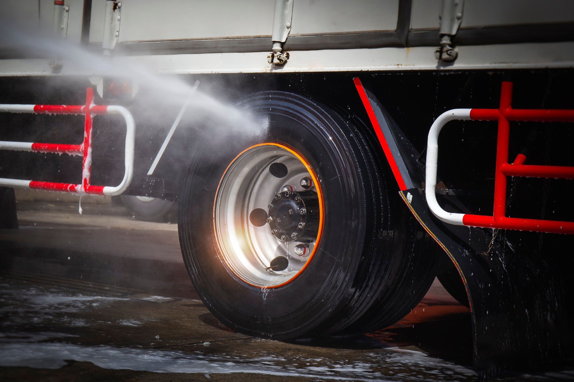 High Pressured Water Washing Truck Wheels. Cleaning Truck Tires